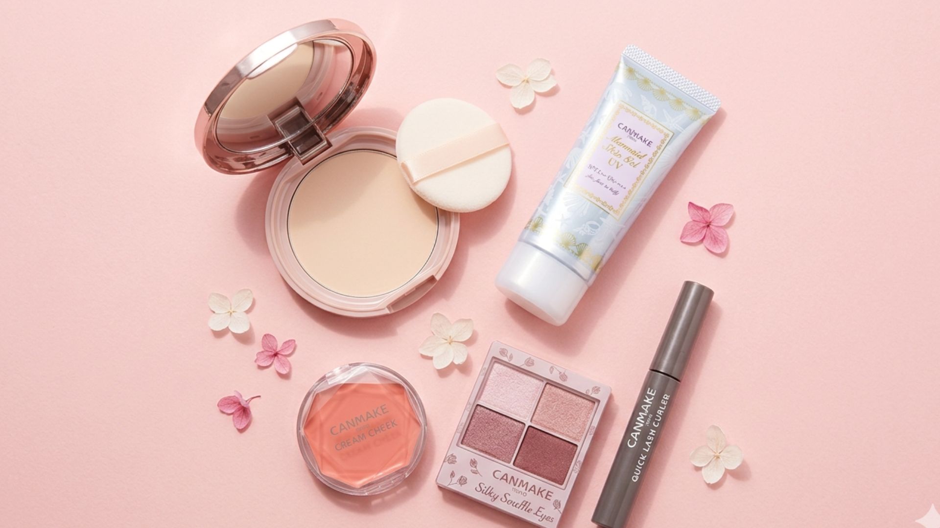 Canmake makeup products arranged on a pink and white surface — Marshmallow Finish Powder, Mermaid Skin UV, Cream Cheek