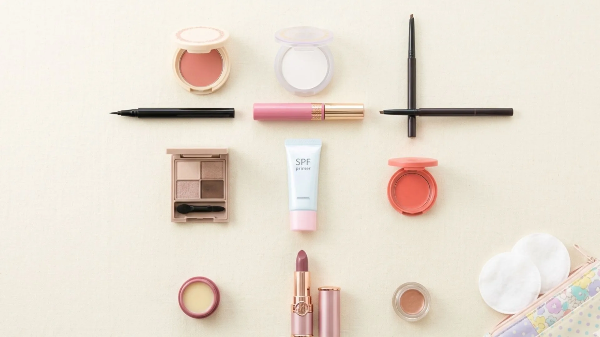 Colorful array of Japanese drugstore makeup products from Canmake, KATE, Cezanne, and Kiss Me Heroine arranged on a white surface