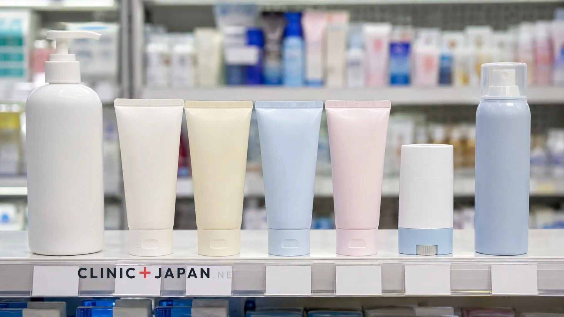 Row of Japanese sunscreen bottles and tubes on a bright drugstore shelf with price tags below each product