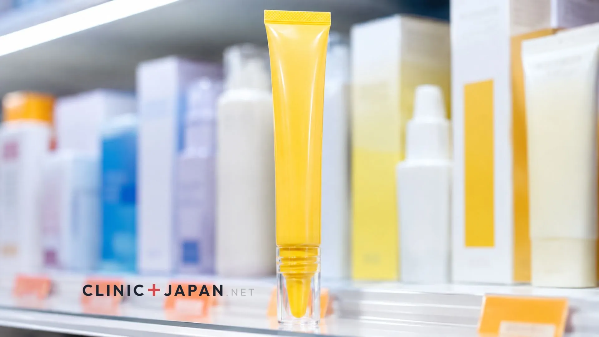 Yellow Melano CC essence tube standing among Japanese drugstore skincare products with price tags on the shelf behind