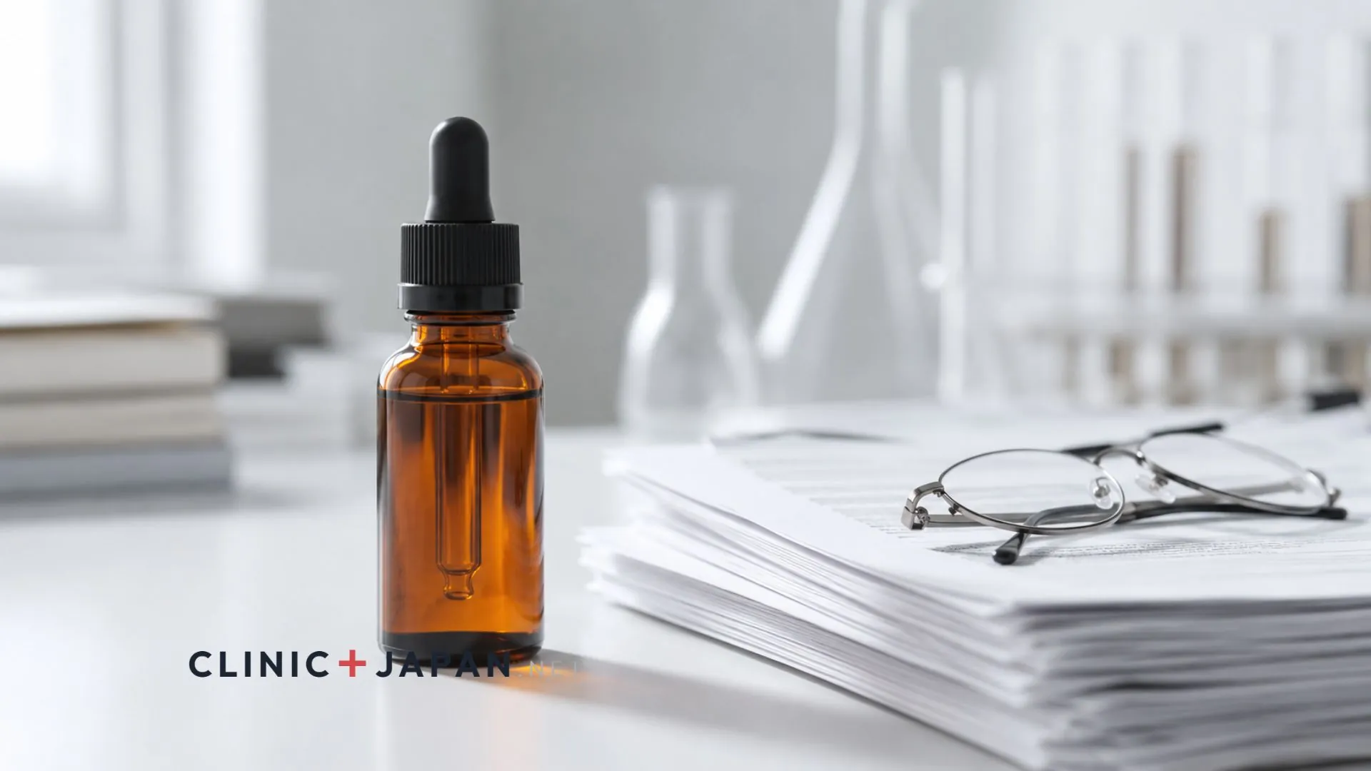 Small dropper serum bottle on a clinical white surface beside a printed research paper and a pair of reading glasses