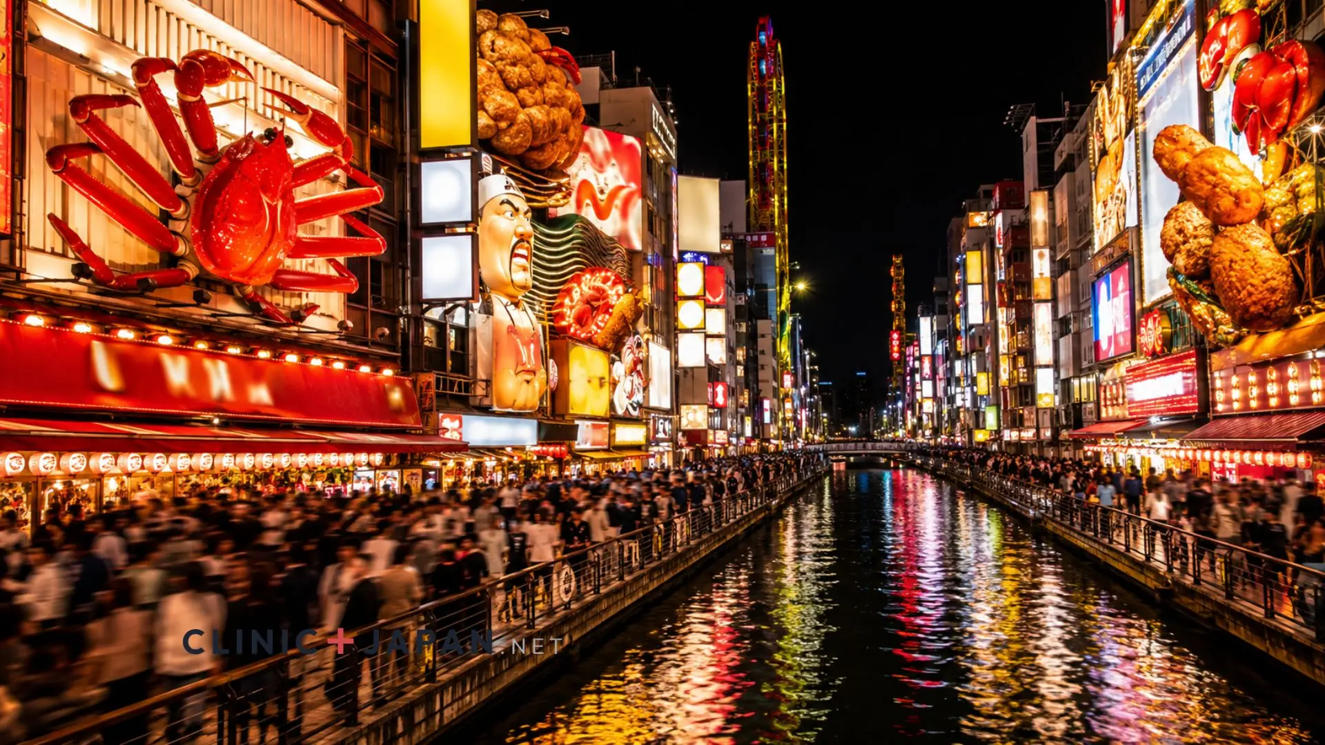 Neon-lit canal-side street in Dotonbori at night, crowded with people beneath oversized illuminated restaurant signs